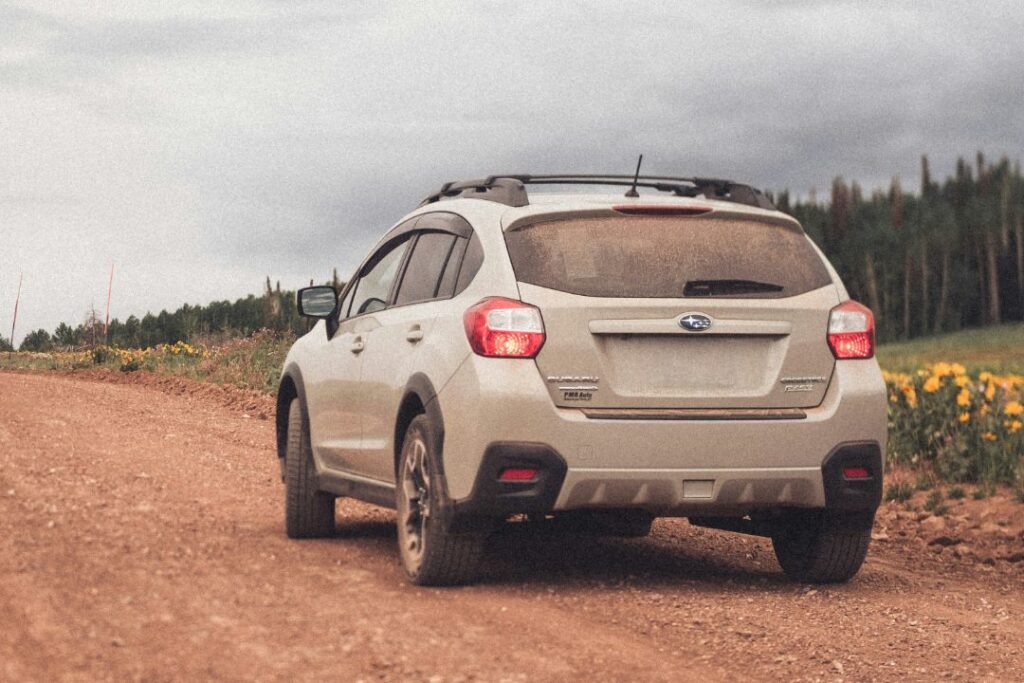 Subaru Crosstrek XV driving down a dirt path