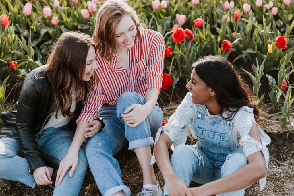 Young people laughing in front of tulip bed